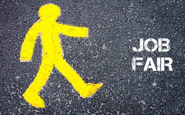 Yellow pedestrian figure on the road walking towards JOB FAIR. Conceptual image with Text message over asphalt background.